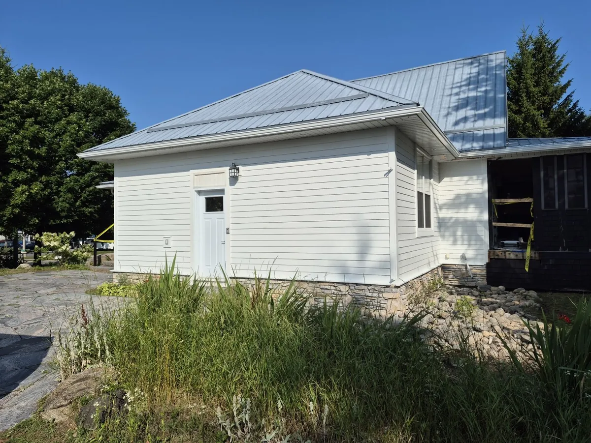 Red siding to a fresh white exterior — After