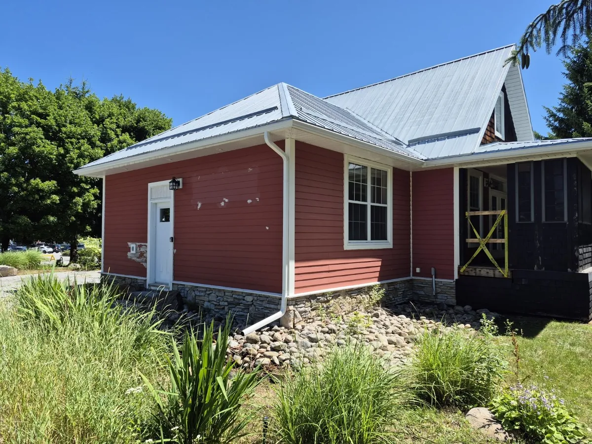 Red siding to a fresh white exterior — Before